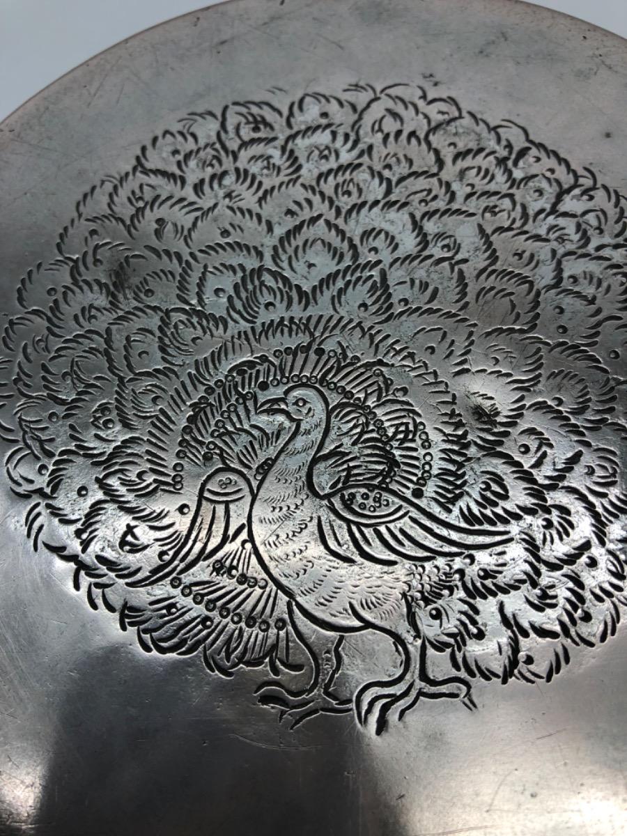A repousse silver bowl by a peacock maker Burma ca 1900