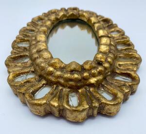 Carved giltwood small sunburst mirror with inclusions 