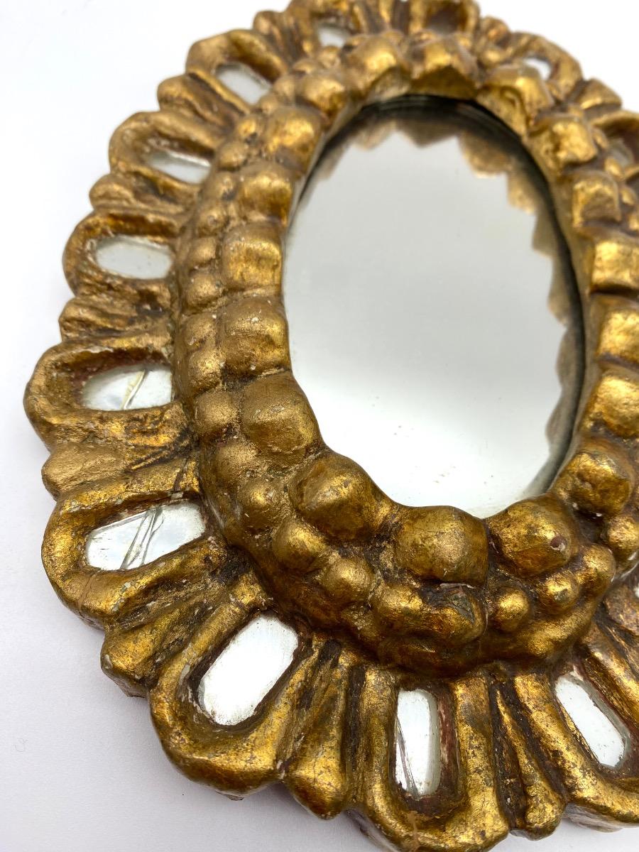 First half XX century French carved small giltwood sunburst mirror with inclusions 