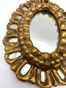 Carved giltwood small sunburst mirror with inclusions 